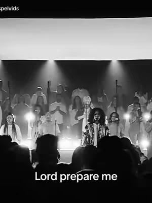 A black and white image of a gospel performance. A choir is in the background. The main subject is a person wearing a jacket with a microphone. The title, 'Lord prepare me', is visible at the bottom of the image.