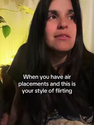 A woman with long black hair looks towards the upper right, a bit above the camera. The text overlay reads, "When you have air placements and this is your style of flirting."