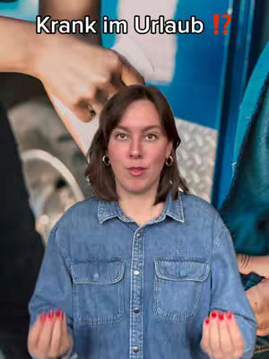 A woman with shoulder-length brown hair is centered, looking towards the camera with a neutral expression. She wears a denim shirt, and her hands, with painted red nails, are open to the camera, as if presenting or explaining something. The background is a blur of colors and shapes.
