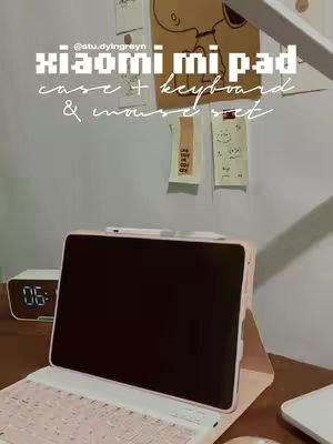 The cover image shows a desk setup with a pink and white keyboard and tablet case. The tablet screen is black. There are sticky notes and a Snoopy drawing in the background.