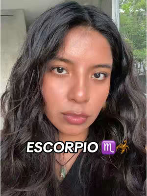 The cover image shows a woman with long, wavy black hair, looking at the camera. Text overlay says 'Escorpio'. A purple zodiac sign and a yellow scorpion are placed to the right of the word Escorpio, indicating the zodiac sign Scorpio.