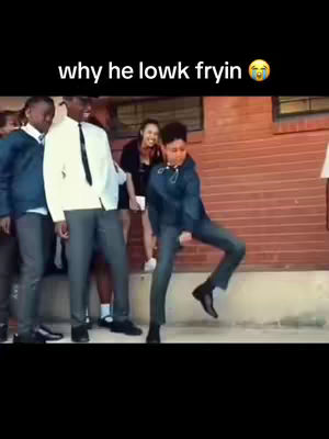 A video still shows a young Black man dancing, with other people in the background and text overlayed on top.