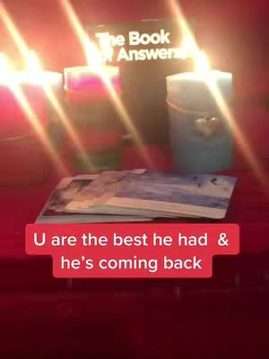 The image displays a spiritual or mystical scene with lit candles, tarot cards, and a book labeled 'The Book of Answers'. The scene is lit with warm, golden light, with a red banner overlaid at the bottom.