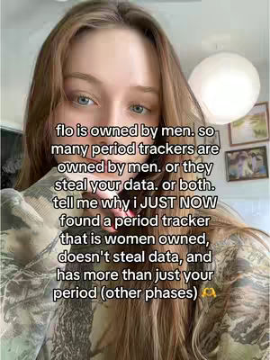 A selfie-style video cover image featuring a young woman with long brown hair, slightly out of focus with background details including a spherical light fixture. Text overlay, discussing period trackers and data privacy, centers on the woman's face.