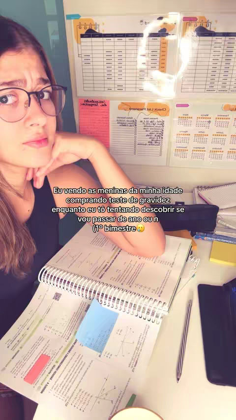 The cover image shows a young woman wearing glasses and looking at the camera with a slightly worried expression. She is in a room with study materials and a motivational board in the background. The layout is a selfie-style shot, with the woman at the forefront. The color scheme is warm, natural light, and a general messy and study-related aesthetic.