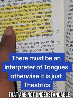 The image shows a page from the Bible with highlighted text and an overlaid blue rectangle containing white text with the message: 'There must be an Interpreter of Tongues otherwise it is just Theatrics THAT ARE NOT UNDERSTANDABLE.' The text is overlaid on a partially visible hand holding the Bible page with yellow highlighted text.