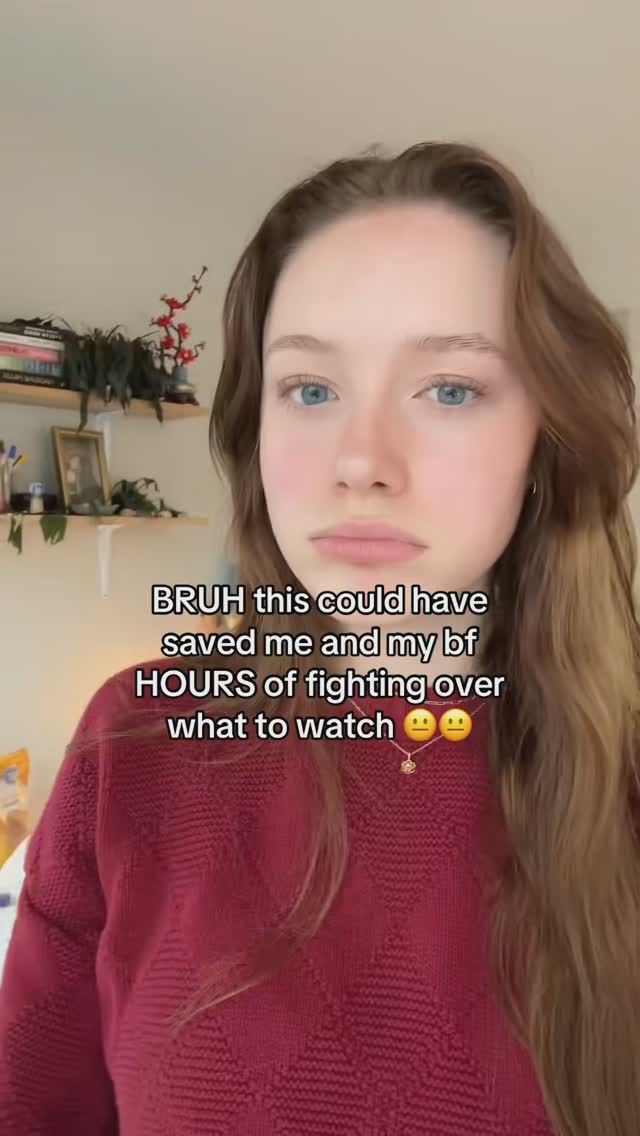 A young woman with light skin and wavy brown hair gazes slightly downward with a neutral expression. Text overlays the image in a casual font; a red sweater adds warmth to the scene, the background is a soft, out-of-focus interior.