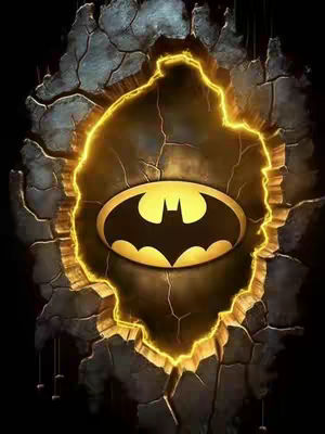 The cover image features a stylized image of the Batman logo. The logo, a black bat silhouette within a yellow oval, is centrally positioned and appears to be breaking through a cracked, textured surface. The background is a dark, possibly black, with the logo and surrounding area being illuminated by golden light, giving a glowing effect and highlighting the cracks in the surface. There are lines or strings of metallic, probably gold color that extend. The cracked surface has cool shades of gray and blue.