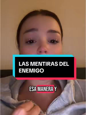 A close-up shot features a young woman with brown hair and fair skin, positioned against a blurred, warm-toned background. She looks directly at the viewer with a slight expression of concern. A teal and black rectangular bar overlays her face, displaying white text that reads, "LAS MENTIRAS DEL ENEMIGO" (The Lies of the Enemy), with additional text "ESA MANERA Y" (THAT WAY AND) in a pink framed rectangular, indicating her focused gaze. The overall composition is simple, concentrating attention on her face and the overlying text.