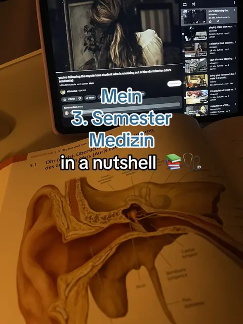The cover image is a screenshot showing a YouTube video on a tablet placed on a desk. The video on the tablet has some text over it. Below the tablet, a book with anatomical diagrams is visible. The central focus is on text overlays which present the message. The color palette has warm tones from lamplight.