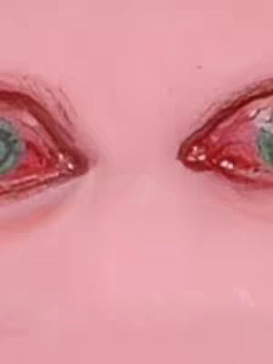 The image is a close-up shot of two eyes against a pink background. The eyes are red-rimmed, suggesting irritation or crying, and the irises are a pale green. The image has a soft, almost watercolor-like quality due to the lack of sharp focus, which adds to the emotional feel. The background is a uniform pink, which provides a simple surrounding.