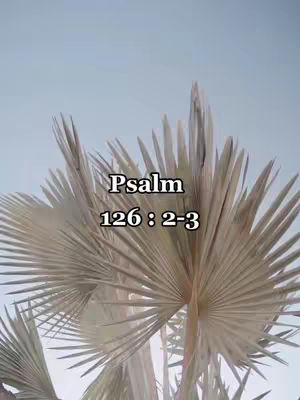An image featuring a fan of palm leaves against a light blue sky. Overlayed on the image is text, labeling it with a Bible verse citation.