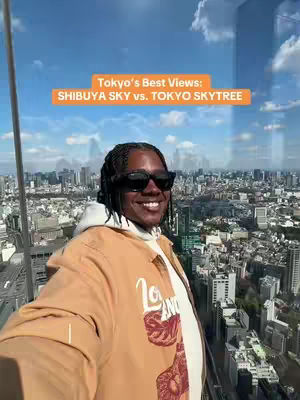 A selfie-style shot of a man in sunglasses and a light brown jacket, standing against a backdrop of an urban cityscape under a blue sky. The image features a text overlay in an orange box at the top.