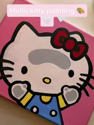 A pink canvas with a hand-painted Hello Kitty illustration. The character is centered and recognizable, with a white face, black outlines, a red bow, and a blue dress. Above the character, a light pink speech bubble contains the text 'Hello kitty painting'. The overall composition is simple and graphic, emphasizing the iconic character.