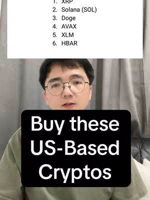 A man with glasses is centered in the frame, against a blurred background. A graphic overlays the man, with the words 'Buy these US-Based Cryptos' in bold white text on a black rectangle.