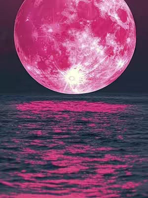 A serene image depicts a vast expanse of water reflecting a large, pink moon. The moon dominates the upper portion of the frame, its surface displaying subtle textures and variations in color, while a clear, bright light is shown from the moon lower center. The water below mirrors the moon, creating a symmetrical reflection of the pink hues across the water's surface.