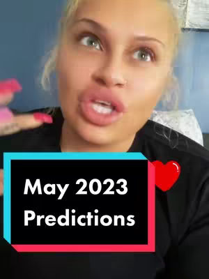 A blonde woman with fair skin and light eyes is positioned in the frame, looking toward the viewers. She is wearing a black top. Overlayed on the shot is a black rectangle with white text that reads, "May 2023 Predictions." A red heart is placed on the right side of the rectangle.