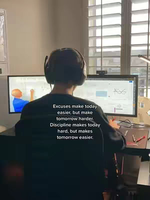A person wearing headphones sits at a desk in front of two computer monitors. The monitor on the left displays a person drawing, the right has what looks like a graph. Text is layered over the image.