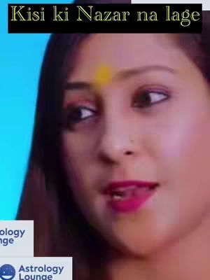 The image shows a close-up of a woman's face, possibly speaking. She has dark hair and is wearing pink lipstick. A yellow symbol is on her forehead. The background is a blurred blue, suggesting a video background. Text at the top in a black box reads, 'Kisi ki Nazar na lage' and logos for "Astrology Lounge" appear in the bottom.