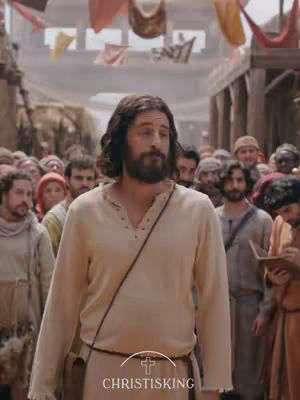 The cover image features a man in a cream-colored tunic, styled to resemble Jesus, walking towards the viewer. He is surrounded by a crowd of people in historical attire. The image has a warm color palette, and the man is the focal point.