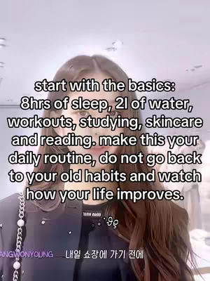 The cover image is a selfie-style shot featuring a person with long, dark hair, looking directly at the camera. The person wears dark clothing, with a portion of a white beaded chain visible on the left side. Overlaid on the image is white text providing a daily routine for self-improvement. The background is slightly blurred and suggests a bright, indoor setting.
