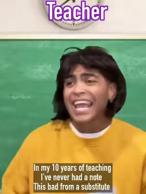 The image shows a young man with dark hair and a yellow sweater, positioned inside what appears to be a classroom setting. A chalkboard is in the background, and a clock is visible. The man is mid-sentence and looks excited. Text overlays include "Teacher" at the top and a caption at the bottom.