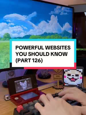 The image shows a person in front of a computer setup with a large monitor displaying a sky and cloud scene. A red Nintendo DS is visible on the desk, along with a keyboard, providing context.