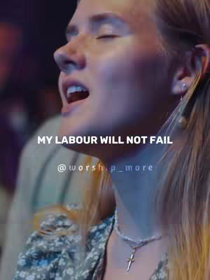 The image shows a close-up of a woman singing, with her eyes closed and mouth open. The background is out of focus but appears to be a stage or performance setting. Overlaid text provides a motivational message.