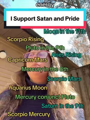 The image features a person, possibly a woman, with long, wavy light brown hair, wearing a dark purple sweater and glasses. Text overlays indicate the creator's support for Satan and pride. A text overlay against a blue and pink background says "I Support Satan and Pride" with other astrological labels arranged next to the creator's face. The background includes outdoor elements like a building and tree.