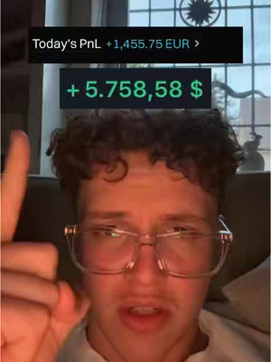 A selfie-style video cover image featuring a young man with glasses, pointing upwards with his right index finger. Two text boxes float above the man's head with financial data in EUR and USD. The background is slightly out of focus, with a window visible.