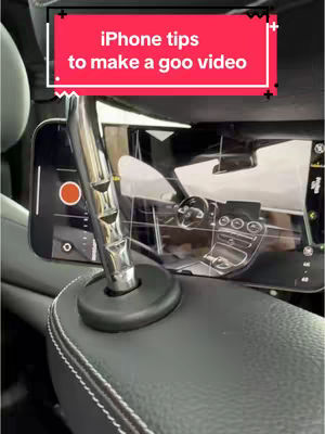 The cover image shows a phone recording inside a car. A phone is mounted to the headrest, displaying the car's interior, with a red record button visible. A text overlay in a red box states 'iPhone tips to make a goo video'. The scene focuses on the inside of the car, offering a tech-related theme.