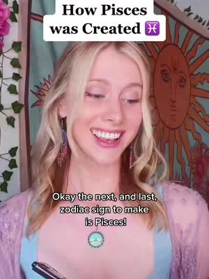 A young woman with blonde hair smiles while looking towards the left. Text overlays read: How Pisces was Created and Okay the next, and last, zodiac sign to make is Pisces!. She wears a light blue top and a pendant necklace. The background features a colorful wall hanging.