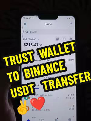 The cover image shows a smartphone screen displaying the Trust Wallet app, with overlaid text in yellow. The screen displays a transaction or balance with the text "TRUST WALLET TO BINANCE USDT TRANSFER". A hand is holding the phone. A peace sign and heart sticker are also included.