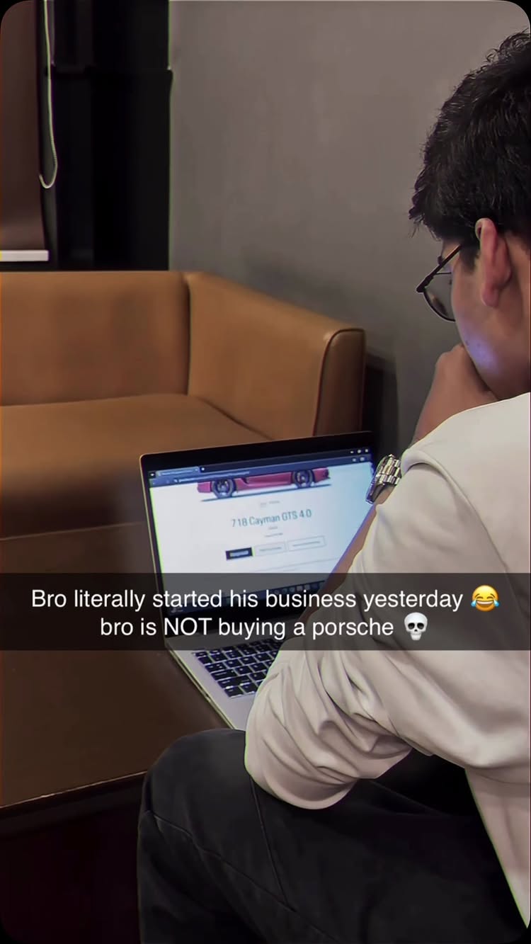 A person wearing glasses looks at a laptop displaying a car website. Text overlays on the image. Behind the person, there's a blurred background with a brown sofa, a neutral wall, and a dark object on the left.