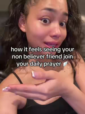 A selfie-style shot of a young woman looking at the camera with wide eyes, a slight smile, and out-stretched hand. Text overlays the image.