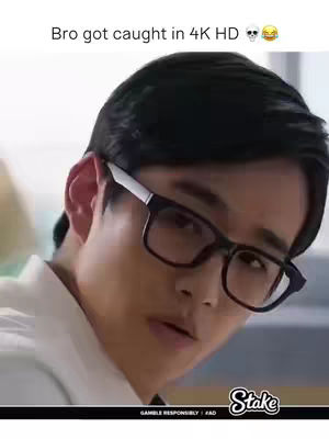 The cover image shows a close-up of a young Asian man's face. He is wearing black-framed glasses and looking slightly to the side with a surprised or caught-off-guard expression. The background is blurry, suggesting a shallow depth of field, and the overall composition is simple, focusing solely on the man's face.