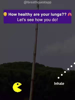 The image is a vertical shot with a purple rectangular text box at the top-center. Inside, white text asks, 'How healthy are your lungs??' and 'Let's see how you do!' with relevant emojis. Below the text, a Pac-Man character in yellow and black is positioned to the left. To the right, there is a dotted white line with the word 'Inhale' at the end. The background suggests a natural setting, with trees and a dark sky, adding depth to the composition.