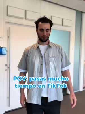 A man with dark hair and a beard stands in a well-lit hallway or office setting. He wears a light gray short-sleeved button-down shirt over a white t-shirt and black pants. The text overlay indicating a "POV" has blue text boxes on the cover image.