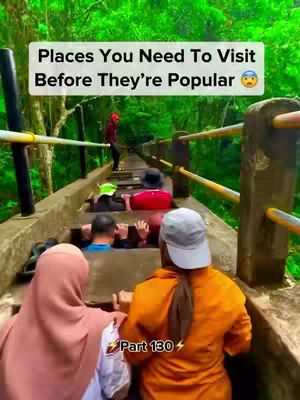 A path with multiple staircases is shown, people are going up the stairs. The environment is a forest with many green trees.