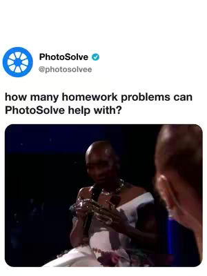 The image shows a screenshot of a post with text and video. The text is from PhotoSolve, asking 'how many homework problems can PhotoSolve help with?'. The video shows a person on stage, likely a singer, in an off-white or cream colored gown, with an elaborate neck piece and holding a microphone. The background is dark with blue lights that appear to be behind stage lighting.