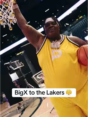 The cover image shows a man in a Lakers basketball jersey holding a basketball and reaching up towards the basket net. A text overlay says "BigX to the Lakers".