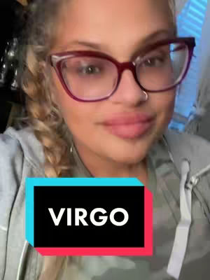 A woman with blonde hair wearing glasses and a gray hoodie is smiling. Overlayed on the image is a black rectangle with a blue upper section and a red lower section containing the word "VIRGO" in white font.