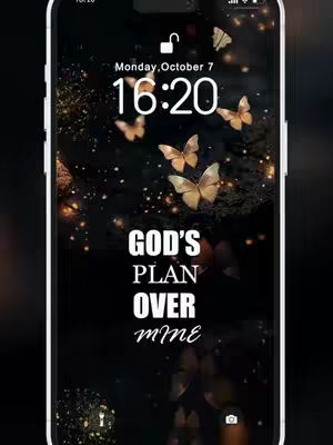 A smartphone screen displaying a black and gold wallpaper featuring various butterflies and the text: 'GOD'S PLAN OVER mine'. The phone is shown inside a white frame.