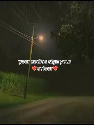A dark, nighttime scene featuring a paved road leading towards a bright streetlamp. A power pole with diagonal wires is in the midground. Text is overlaid on top, and the overall atmosphere is dim.