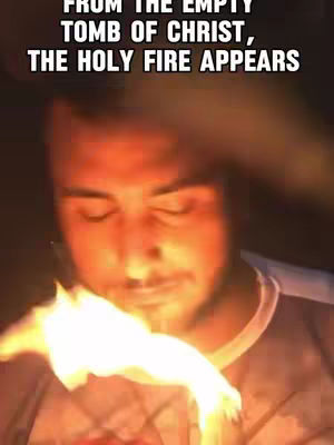A man with his eyes closed appears in the image, as a flame spreads from his hands. The background is a dark, blurred setting. The text overlay reads, "FROM THE EMPTY TOMB OF CHRIST, THE HOLY FIRE APPEARS."