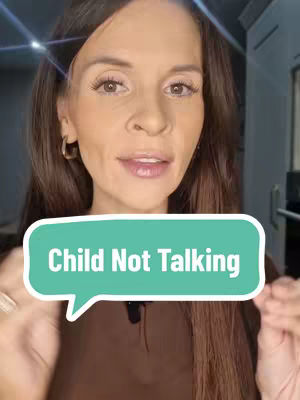 A woman with long brown hair is centered in the frame, looking towards the camera. A speech bubble graphic with rounded edges that reads \"child not talking\" in white, bold font, is placed in front of her, partially obscuring her torso. The background is blurred, and the overall composition is brightly lit, suggesting a casual or informational video format.