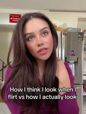 A woman with long brown hair gazes at the camera, her expression earnest. Overlayed text at the bottom reads, "How I think I look when I flirt vs how I actually look."