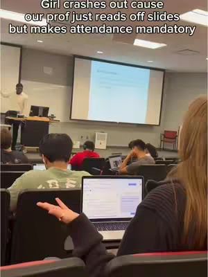 A cover image of a lecture hall with students. The focus is on the back of a student's head, with their arm extended as if gesturing towards a laptop. A screen in the background displays a presentation. The room has other students and a speaker at the podium.