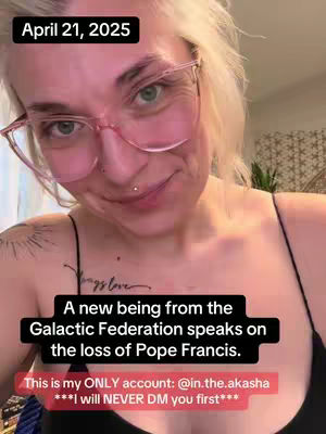 A selfie-style video cover featuring a woman with blonde hair wearing pink-rimmed glasses. The time stamp 'April 21, 2025' is in a black box at the top left. Text overlays are placed at the bottom, against a blurred background. The woman's expression is neutral with a slight smile. Tattoos are visible on her chest/shoulder.