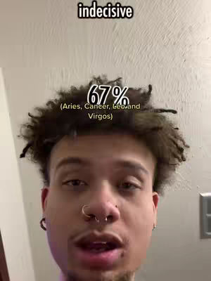 A selfie-style video featuring a young man with dark, curly hair. He has multiple facial piercings - a nose ring and earrings. Above him is a text overlay saying 'indecisive'. In the center is a percentage overlay of '67%' with text below it indicating 'Aries, Cancer, Leo andVirgos', and a light-colored wall in the background.